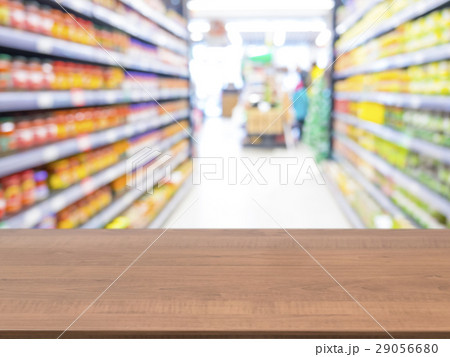 Wooden empty table in front of blurred supermarket Wooden empty table in front of blurred supermarket 29056680