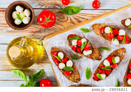 bruschetta with tomatoes, mozzarella and basil 29056821