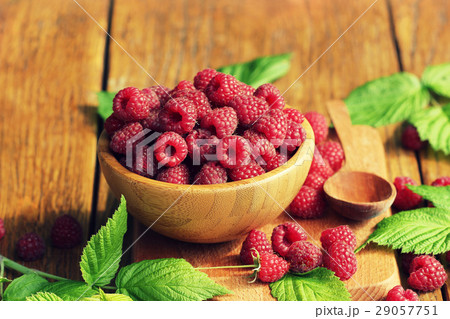Ripe fresh raspberry in wooden bowl 29057751