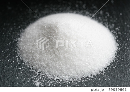 heap of extra small salt on black slate background heap of extra small salt on black slate background 29059661