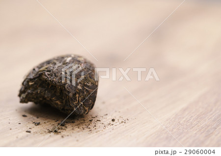 part of raw green puerh tea on wood table part of raw green puerh tea on wood table 29060004