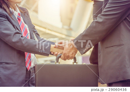 Business man and businesswoman handshake at city 29060436