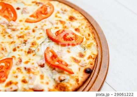 pizza on wooden plate 29061222