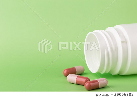 Brown pills and a bottle of medicine Brown pills and a bottle of medicine 29066385