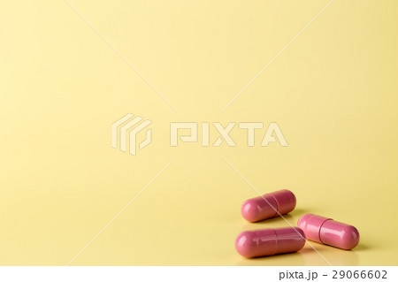 Red medicine pills on bright background Red medicine pills on bright background 29066602