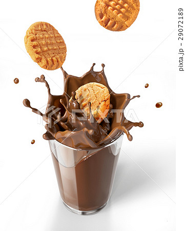 Two cookies biscuits falling into chocolate milkshake glass, forming a crown splash. 29072189