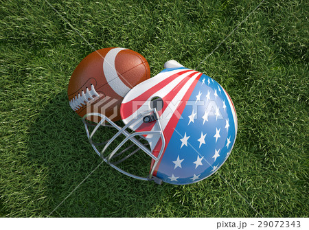 American football helmet decorated as US flag and ball, on the grass. Close up. 29072343