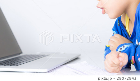 Baby boy is excited by what is on the computer screen 29072943