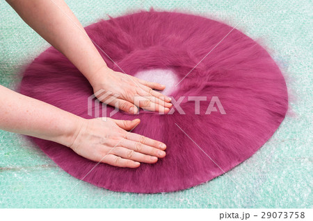 milliner presses fibers on back side of hat layout 29073758