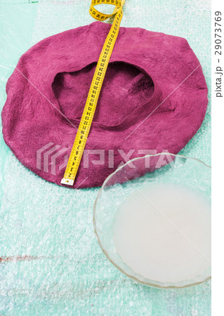 wet felt beret is forming on table wet felt beret is forming on table 29073769