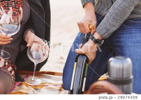 Young happy couple enjoying picnic on the beach Young happy couple enjoying picnic on the beach 29074309