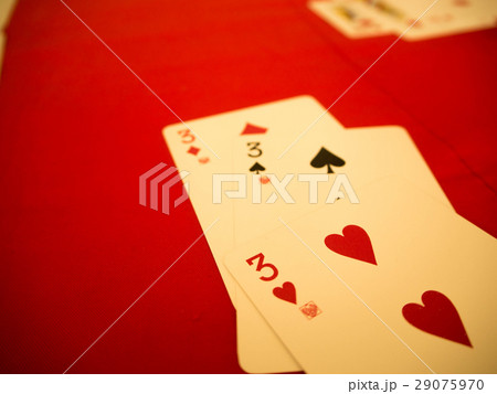 Playing cards on red table 29075970