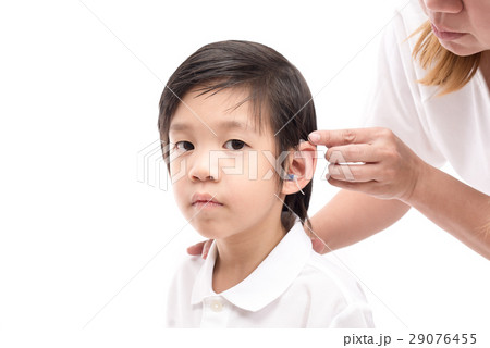 Doctor Inserting Hearing Aid 29076455