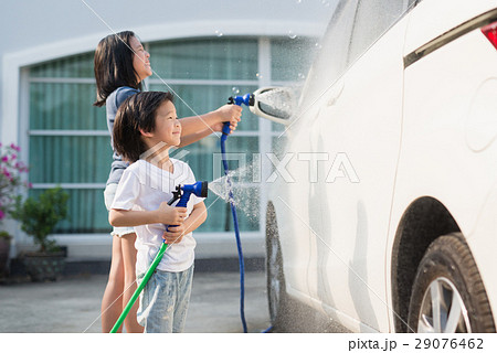 Asian children washing car in the garden Asian children washing car in the garden 29076462