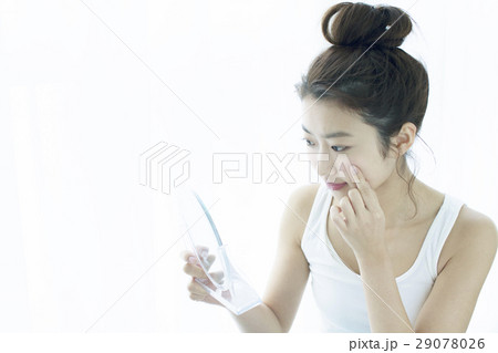 肌の様子をチェックする20代女性 29078026