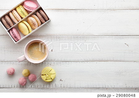 Feminine workspace with macarons and coffee 29080048