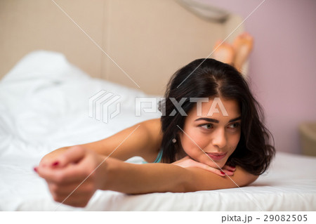Lady lying in bed. 29082505