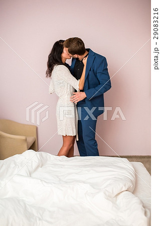 Woman kissing man in suit. Woman kissing man in suit. 29083216