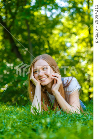 Beautiful smiling red-haired young woman 29084211