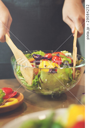 Woman cooking salad with vegetables. 29084252