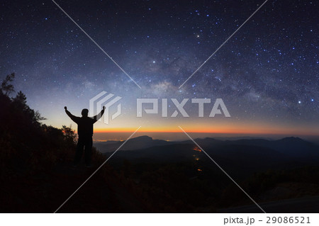 milky way galaxy and silhouette of a standing man  29086521