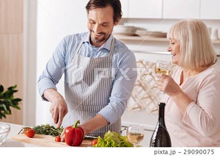 Careful mature son helping aged mother in the Careful mature son helping aged mother in the 29090075