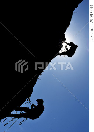 Silhouette of a rock climber hanging on the wall 29092244
