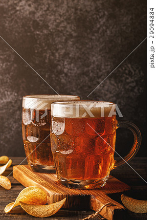 Cold beer in glass on a dark background. 29094884