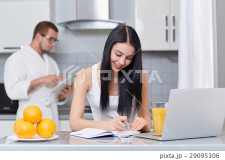 Couple using gadgets and planning day. Couple using gadgets and planning day. 29095306