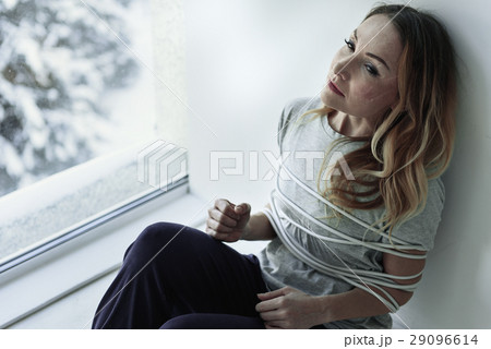 Tied despaired woman in room 29096614