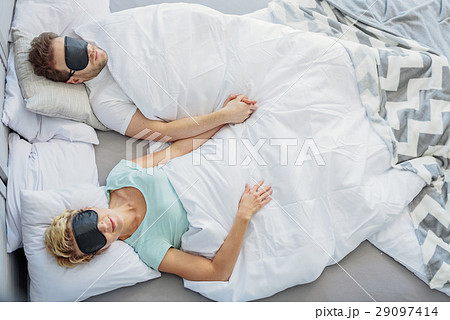 Tranquil husband and wife enjoying dreams on bed 29097414