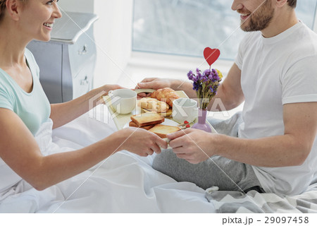 Cheerful married couple having romantic breakfast Cheerful married couple having romantic breakfast 29097458