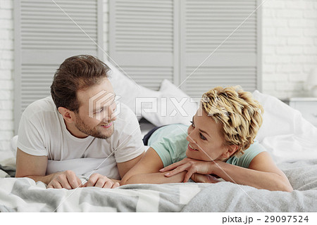 Happy married couple lying on bed Happy married couple lying on bed 29097524