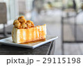 A piece of caramel cake with macadamia topping 29115198