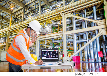 Engineer using computer for maintenance in factory 29115968