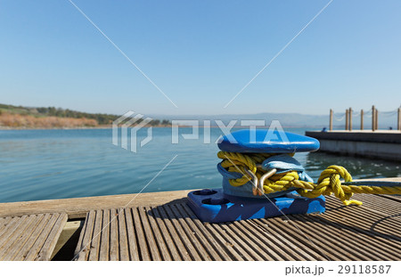 Blue mooring bollard with yellow rope 29118587