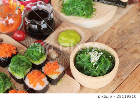 Sushi roll with seaweed salad and shrimp eggs. 29119810