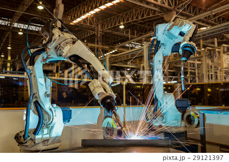 Team robot are welding steel part in factory 29121397