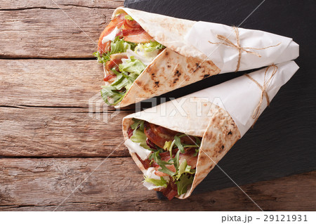 Burritos with bacon and fresh mix of salad 29121931
