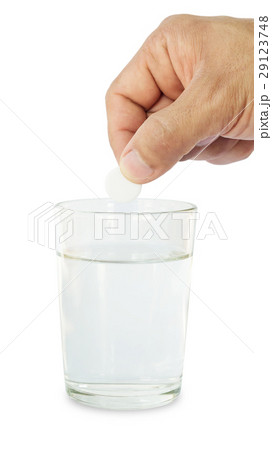 Man holding medicine on a glass of water. 29123748
