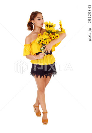 Beautiful woman standing with sunflowers. 29129345