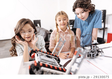Shocked kids observing electronic robots at school Shocked kids observing electronic robots at school 29130075