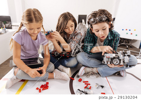 Cheerful kids using gadgets and devices in the Cheerful kids using gadgets and devices in the 29130204