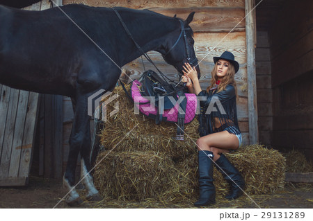 Woman cowboy with a horse. 29131289