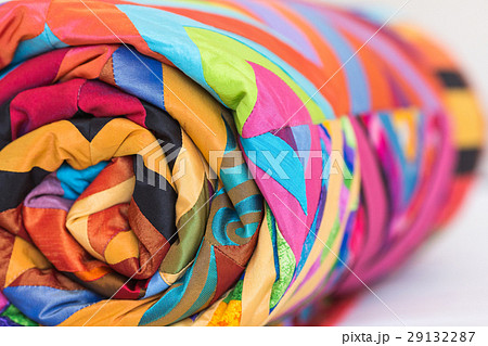 Colored patchwork quilt twisted into close up 29132287
