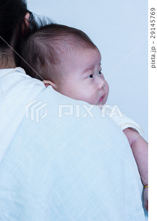 Baby resting on mother's shoulder. Mother's Day Baby resting on mother's shoulder. Mother's Day 29145769