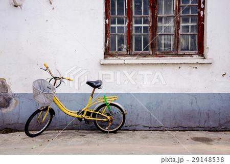 Old side street with a vintage old yellow bike Old side street with a vintage old yellow bike 29148538