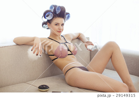 Woman applying make-up indoors 29149315