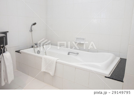 bathtub with shower in white bathroom 29149795