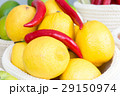 lemons and chili peppers in a wicker baske 29150974